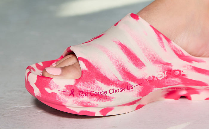 Pink and white sandal with 'The Cause Chose Us' text on a neutral background | lifesyle
