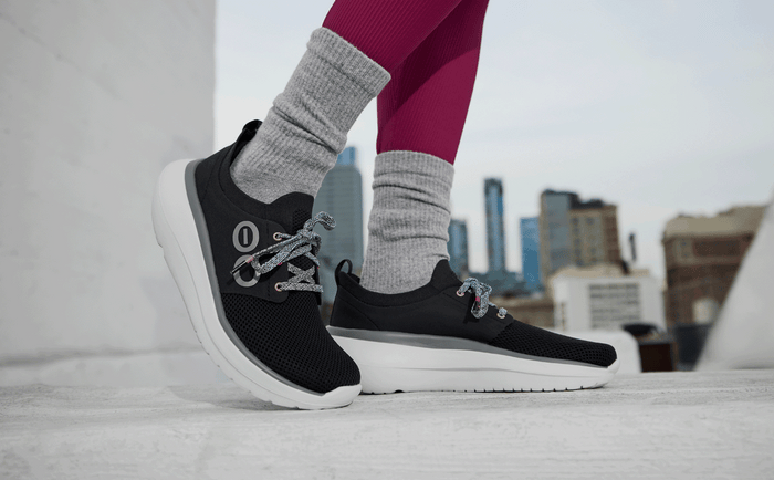 Women's OOmy Stride - White Black model posing outside | lifestyle
